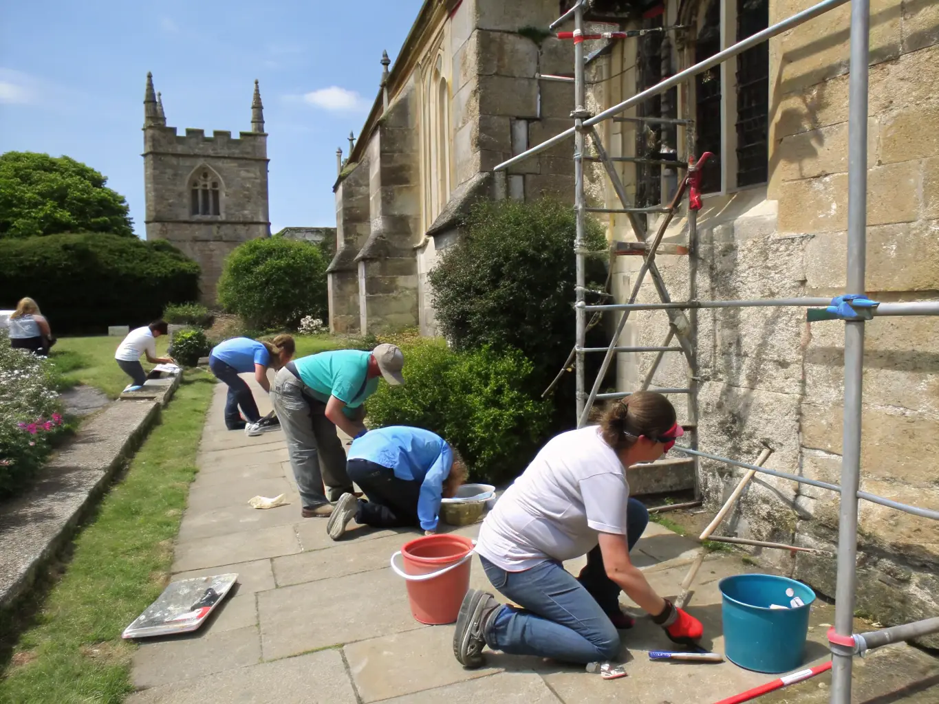 An inspiring image of volunteers working together on a heritage preservation project organized by LA VIE LA, demonstrating the organization's commitment to preserving cultural heritage.